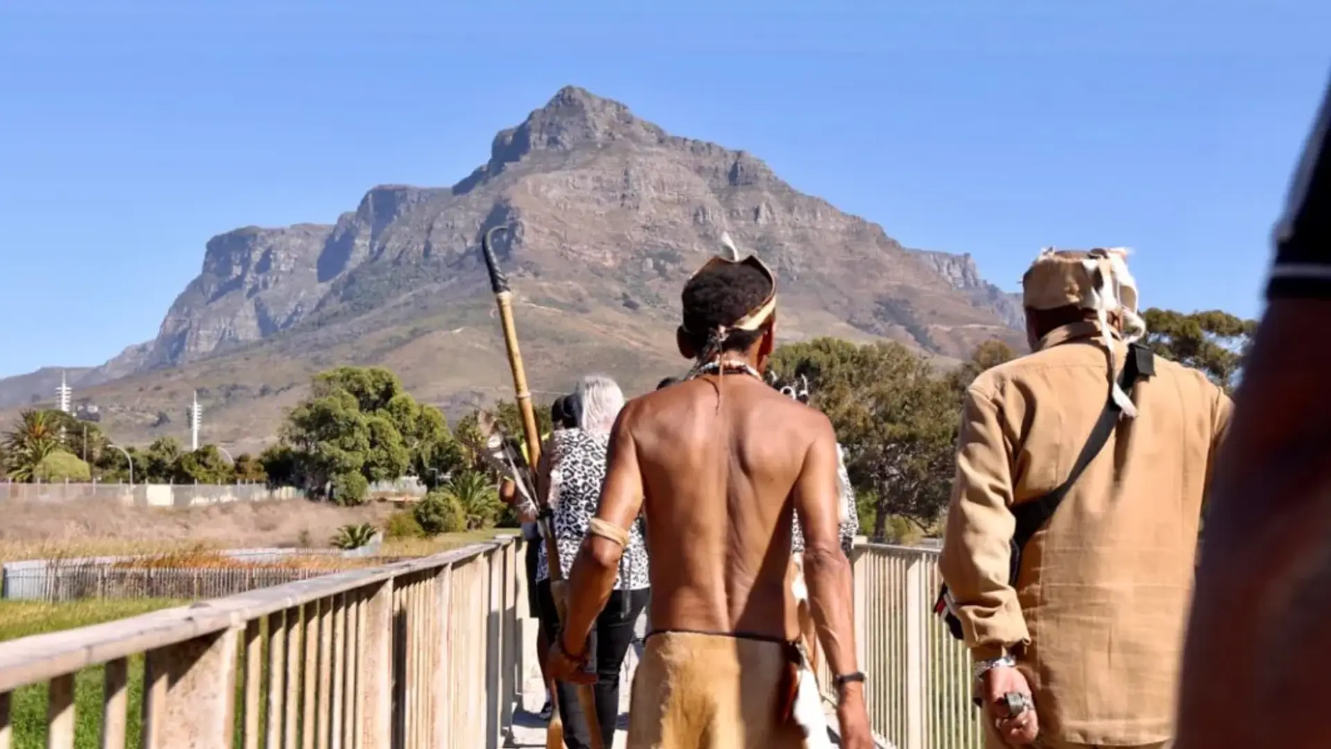 Khoisan men crossing a pedestrian bridge