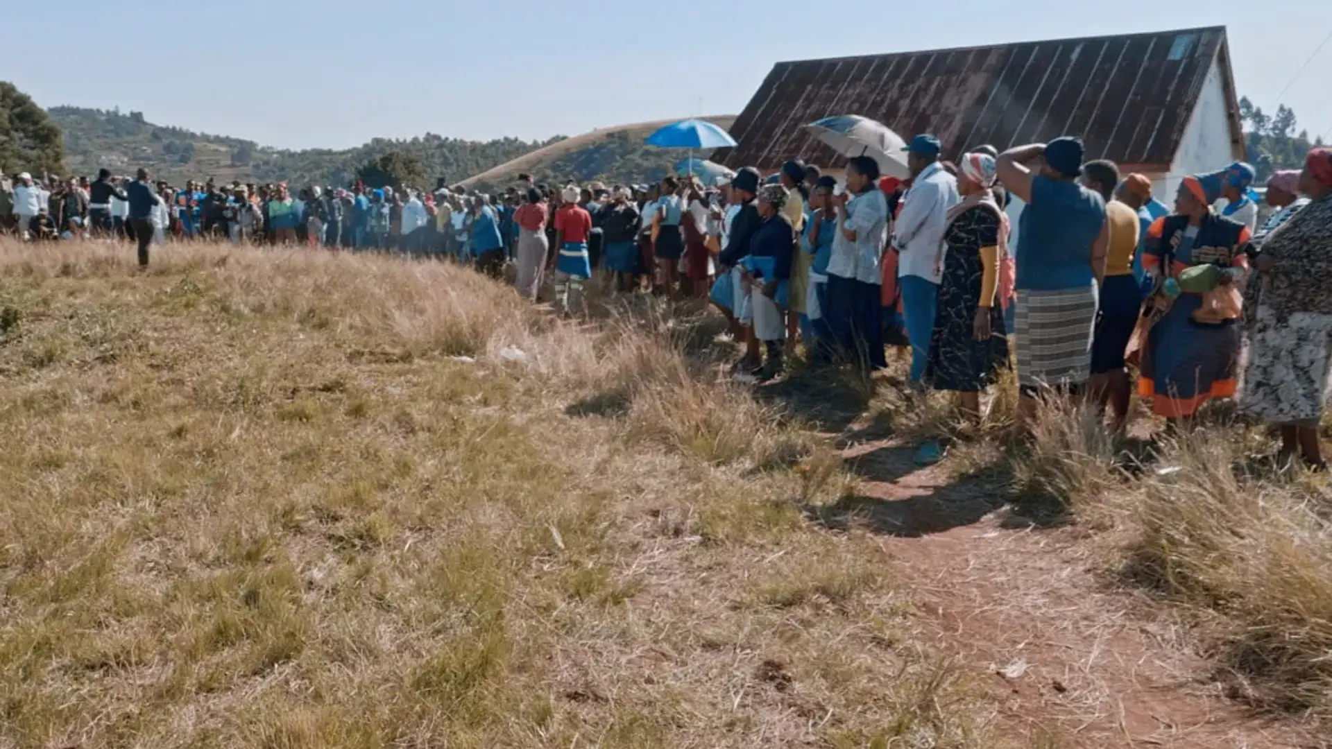 Elderly people standing at a long queue