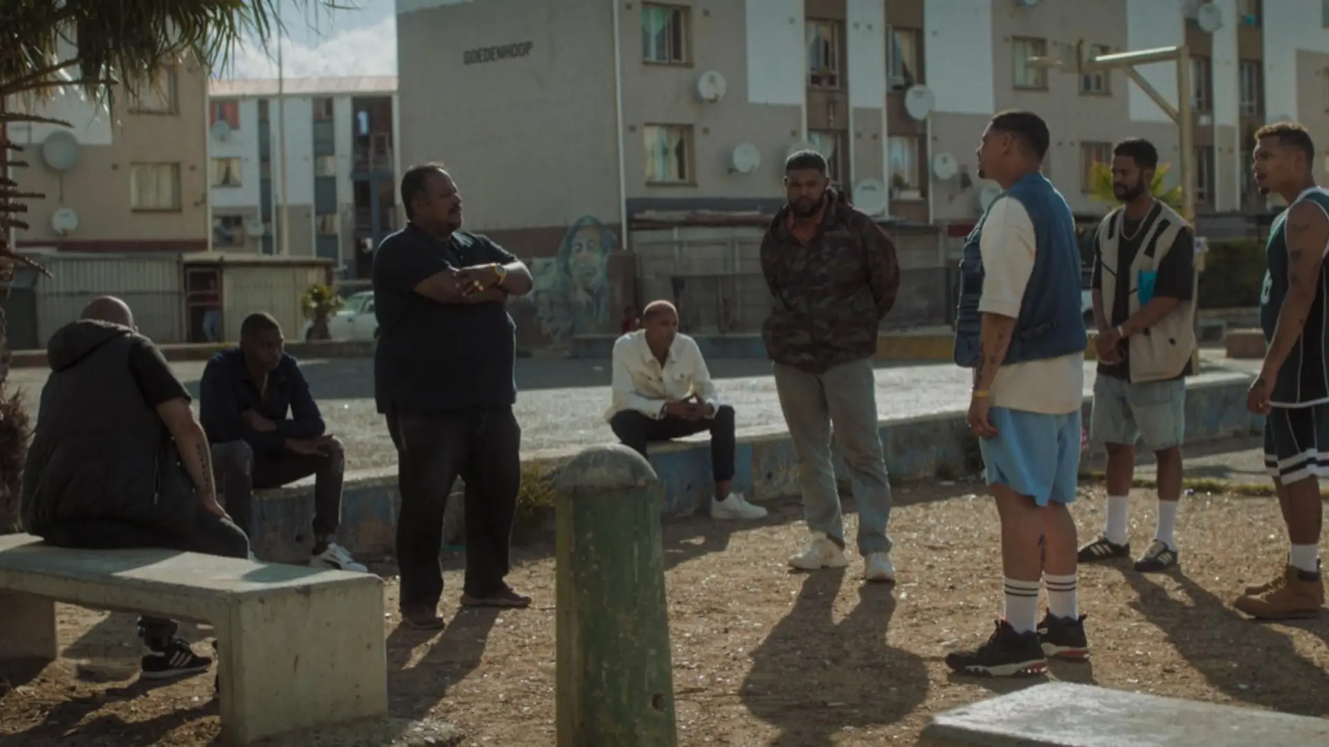 Men hanging out in a park.